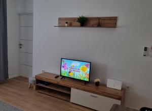 a flat screen tv sitting on top of a wooden table at RetFala Inn in Osijek