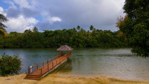 a dock with a hut in the middle of a lake at MG Cocomo Resort Vanuatu in Port Vila
