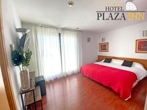 A bed or beds in a room at Hotel Plaza Inn