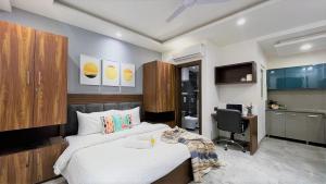 a bedroom with a bed and a desk and a computer at ZEN Studios - DLF CyberCity Gurgaon in Gurgaon