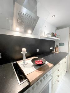 a kitchen with a bowl of fruit on a counter at Ginius Homes - Eifelglück im Grünen in Kall +6 photos