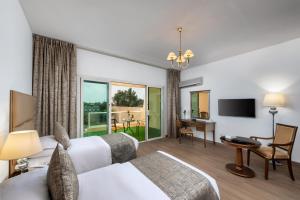 a hotel room with two beds and a desk at Airport Hotel in Abha