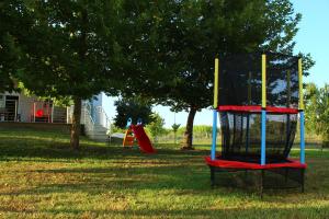 a playground with a play equipment in a park at VILLA DIAMOND Κουρούτα Αμαλιαδος in Amaliás