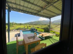 a view of a patio with a table and a pool at Casita Blanca Jala-Jala - Tiny House & Farm Stay in Jalajala