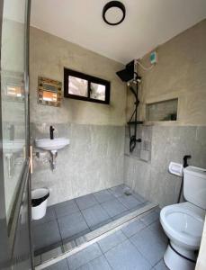 a bathroom with a toilet and a sink at Casita Blanca Jala-Jala - Tiny House & Farm Stay in Jalajala +23 photos