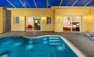 a swimming pool in a house with a bedroom at Airport Hotel in Abha