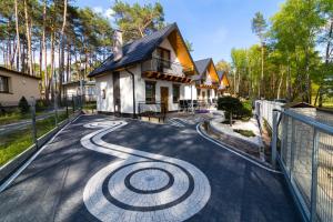 a house with a spiral design on the driveway at Zatoczka Turawa in Turawa