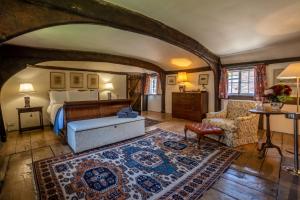 a bedroom with a bed and a couch and a chair at The House with Two Front Doors in Rye