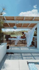 a person laying on a bed on a patio at וילה-ליה in Caesarea