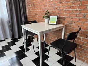 a white table with two chairs and a laptop on it at 3l9B Chiangmai Gate Best location 3 bedrooms apartment in Chiang Mai