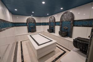 a bathroom with a tub and a toilet in it at Costera Hotel in Istanbul