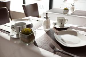 a table with plates and cups on a table at Arena am Zoo in Frankfurt