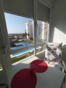 a room with a chair and a table and a window at Flamenco playa in El Puerto de Santa María