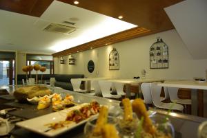 a restaurant with plates of food on a table at Hotel El Acebo in Jaca