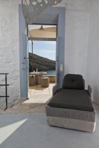 a bed in a room with a view of the ocean at Coco-Mat Eco Residences Serifos in Vayiá