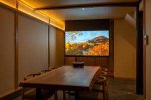 a conference room with a table and a television at Hanatoki Machiya House in Kyoto