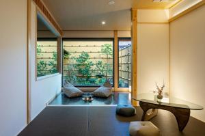a room with a glass table and a window at Hanatoki Machiya House in Kyoto