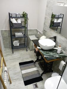 a bathroom with a sink and a mirror at STONEHOUSE & CASA AL SOLE e AL MARE in Nea Roda