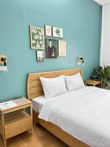 a bedroom with a bed and a blue wall at Hidden Hue Homestay in Hue +117 photos