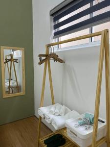 a room with a bunk bed with towels and a mirror at Hidden Hue Homestay in Hue