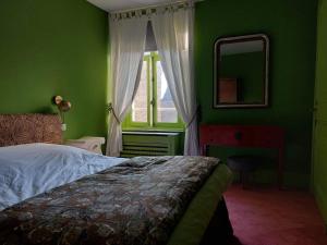 a green bedroom with a bed and a window at Superbe appartement, face à la vieille ville ! in Boulogne-sur-Mer