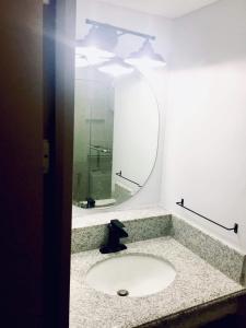 a bathroom with a sink and a mirror at condo-living at its best in Manila