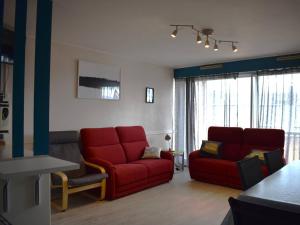 ein Wohnzimmer mit zwei roten Stühlen und einer roten Couch in der Unterkunft Appartement Font-Romeu-Odeillo-Via, 4 pièces, 8 personnes - FR-1-580-28 in Font Romeu Odeillo Via