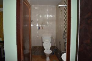 a small bathroom with a toilet and a sink at Kanikasundari Home Stay in Bālianta