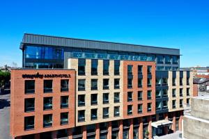 a tall building with a sign on the front of it at Staycity Aparthotels Dublin City Centre in Dublin