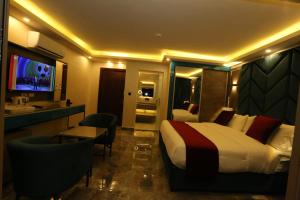 a hotel room with a bed and a television at Petra Sella Hotel in Wadi Musa