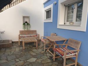 a patio with chairs and a table and a window at Aegean Villita on beach apartment in Kalymnos