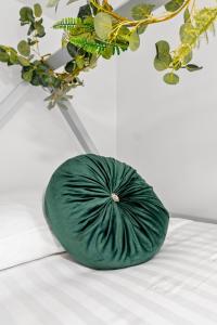 a green bowl sitting on a table next to a plant at The Treehouse at The Hideaway STAMP SA in Blackpool