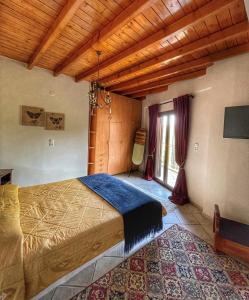 a bedroom with a large bed in a room at Xenonas Vasilikou in Valtessiniko