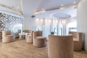 a waiting area with chairs and tables in a room at Agripas Boutique Hotel in Jerusalem