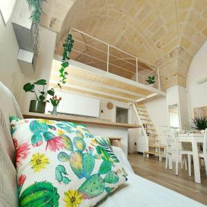 a room with a couch with a pillow on it at Fico Puglia in San Vito dei Normanni