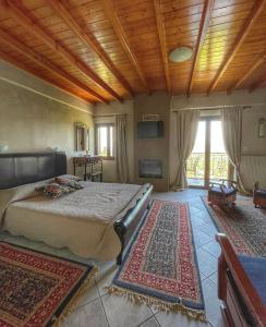 a bedroom with a bed and a wooden ceiling at Xenonas Vasilikou in Valtessiniko
