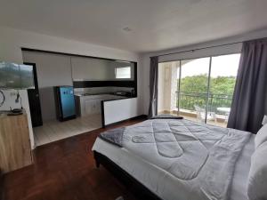 a bedroom with a large bed and a balcony at Chaweng Residence in Chaweng