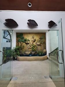 a room with a wall with a painting on it at Chaweng Residence in Chaweng
