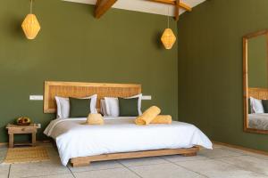 a bedroom with a large bed with green walls at Oasis212 Dakhla in Dakhla