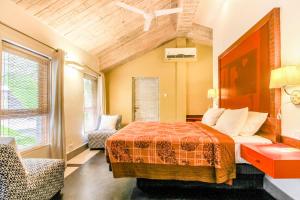a bedroom with a bed and a couch and a window at Casa Vagator in Vagator +100 photos