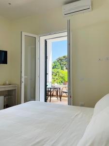 a bedroom with a bed and a view of a table at Alemar Bed & Breakfast in Mondello