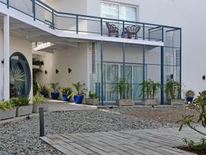 a building with a balcony and potted plants at Ambiance Boutique Art Hotel Karachi in Karachi