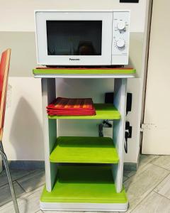 a microwave oven sitting on top of a shelf at Casa San Vincenzo, un nido nel cuore di Genova. in Genova