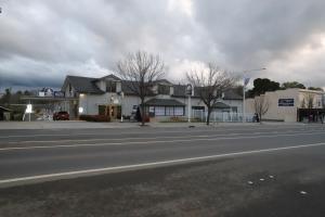 an empty street in a town with houses at Townhouse Motel Cowra in Cowra