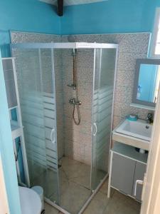 a bathroom with a shower and a toilet and a sink at VILLA AICHY in Rabi