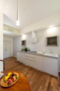 a kitchen with a plate of fruit on a table at Mocenigo Grand Canal Luxury Suites in Venice