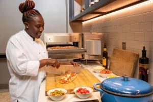 a woman standing in a kitchen preparing food at Hyatt Regency Jacksonville Riverfront in Jacksonville