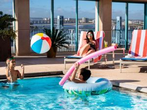 two children are playing in a swimming pool at Hyatt Regency Jacksonville Riverfront in Jacksonville