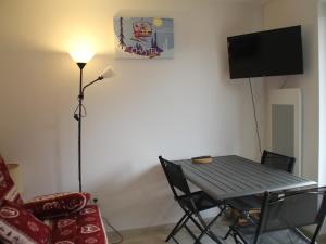 Pokój ze stołem, krzesłem i telewizorem w obiekcie Studio Châtel, 1 pièce, 3 personnes - FR-1-200-353 w mieście Châtel