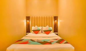 um quarto com uma cama com duas almofadas em FabExpress Gateway Inn em Mumbai